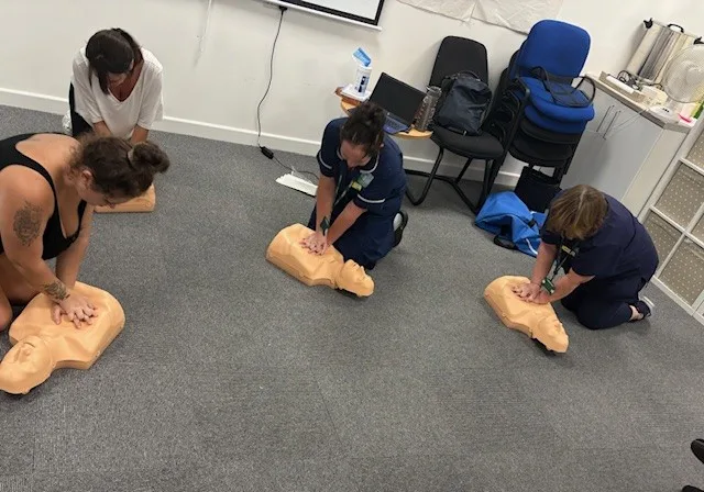 image of people doing cpr on manikins