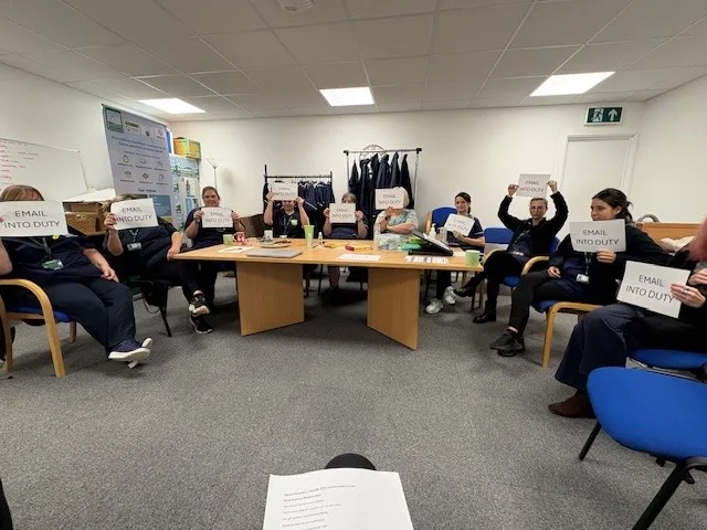 Broomfield care staff holding up signs that read "email into duty"