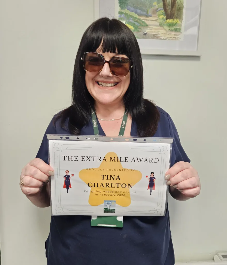 tina from broomfield care with her extra mile award